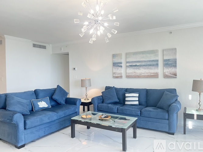 A living room with a blue couch and a coffee table.