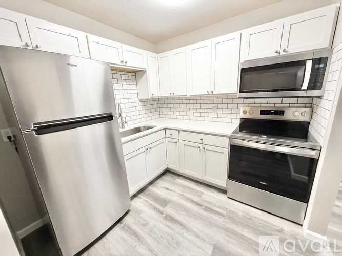 A kitchen with a stainless steel refrigerator and an oven.