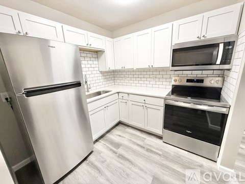 A kitchen with a stainless steel refrigerator and an oven.