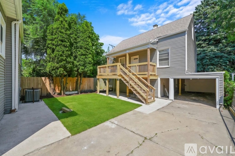 A house with a large backyard and a deck.