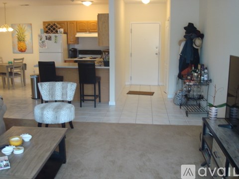 A kitchen with a dining table and chairs in the foreground.