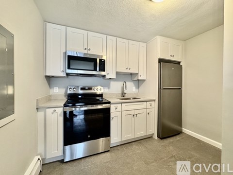A kitchen with white cabinets and stainless steel appliances.
