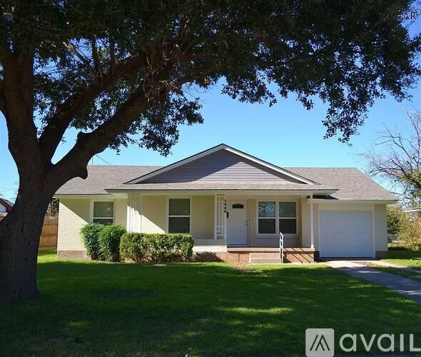 A house with a tree in front of it.