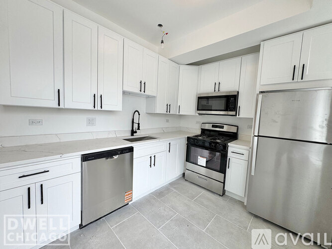 A kitchen with white cabinets and a black stove top oven.