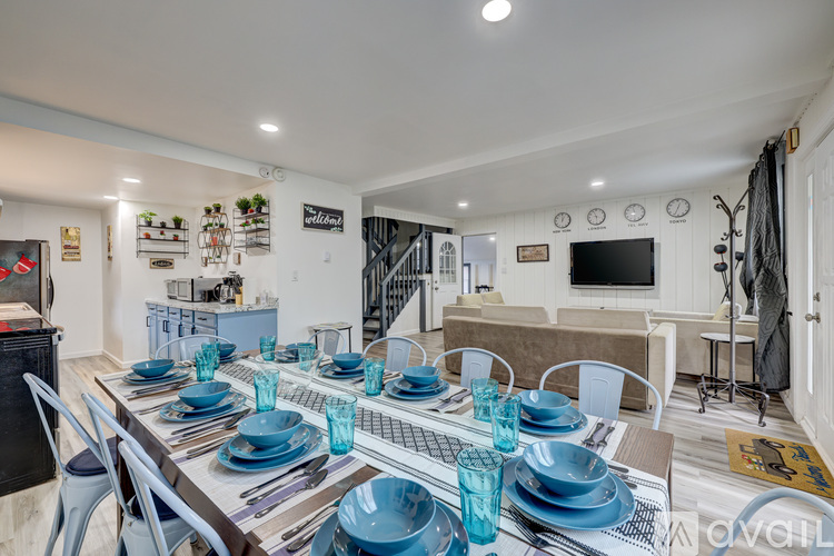 A dining room with a long table set for a meal.