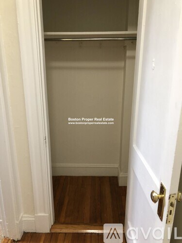 A white door with a gold handle and a glass window above it.