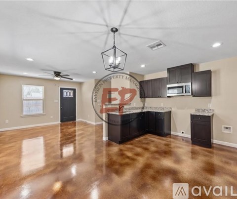 A spacious kitchen with dark brown cabinets and a central island.