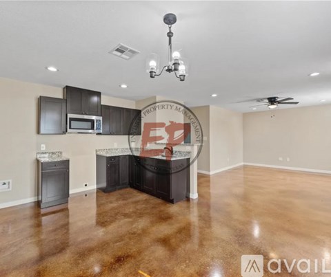 A spacious kitchen area with a microwave, oven, and a dining table with chairs.