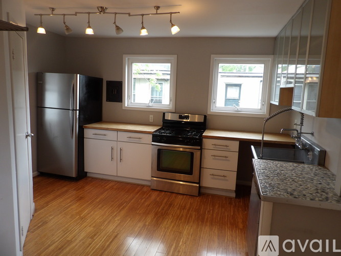 A kitchen with a refrigerator, stove, and oven.