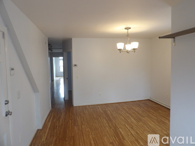 A bedroom with a bed, desk, and chair.