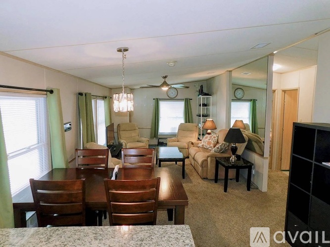 A living room with a dining table and chairs.