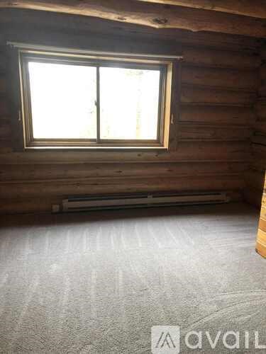 A wooden deck with a railing and a tiled floor.