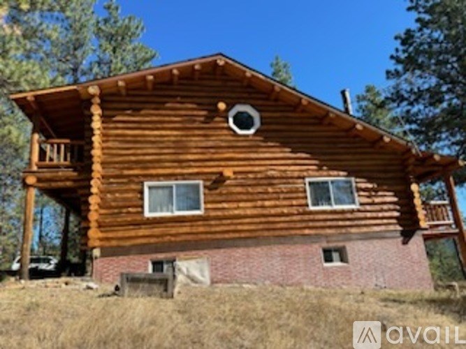 A wooden house with a porch and a balcony.