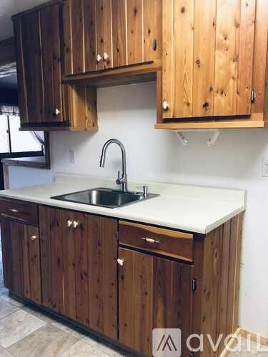A kitchen with wooden cabinets and a white countertop.