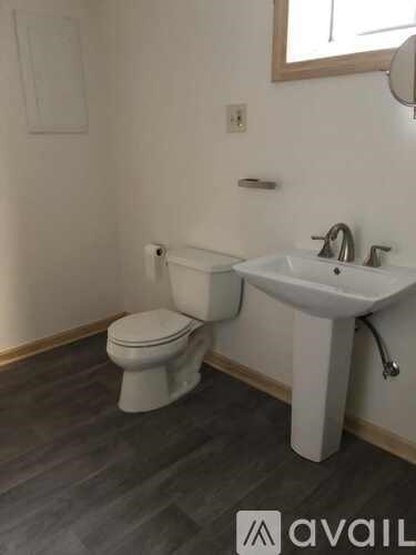 A white toilet and sink in a bathroom.