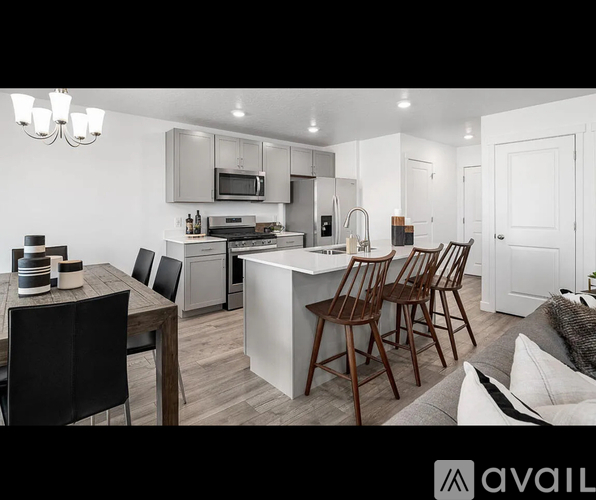 A modern kitchen with a dining table and chairs.