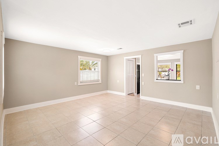 A boat is docked at a pier with palm trees in the background.
