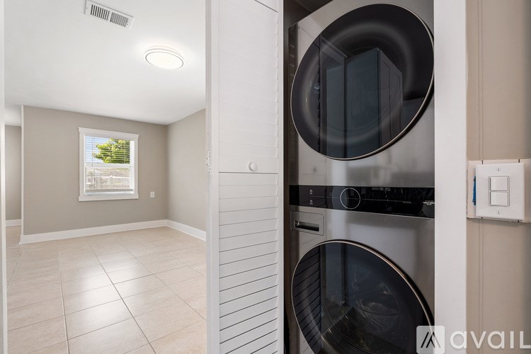 A modern kitchen with a washing machine built into the cabinetry.