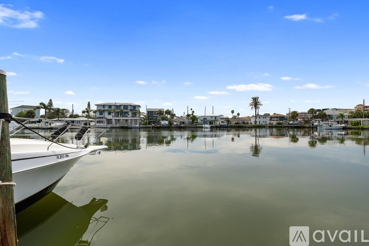 A boat is docked at a pier on a calm body of water.