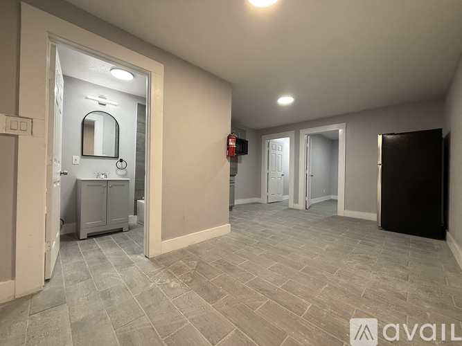 A bathroom with a toilet, sink, and mirror.