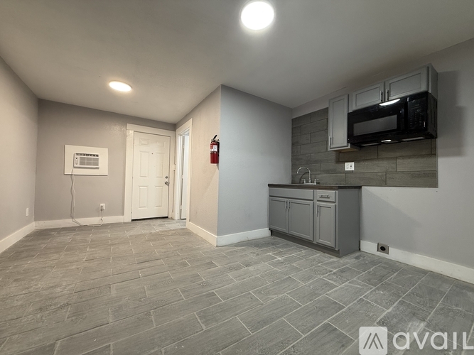 A kitchen area with a microwave above the counter.