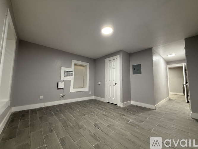 A room with a tiled floor and a white door.