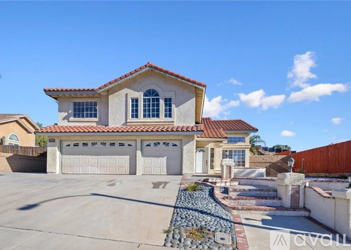A house with a red tile roof and a garage.