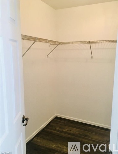 A kitchen with white cabinets and appliances.
