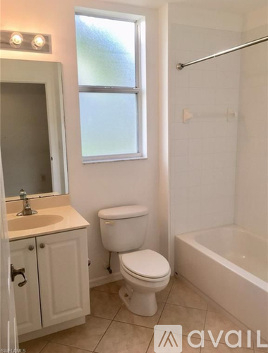 A bathroom with a toilet, sink, and bathtub.