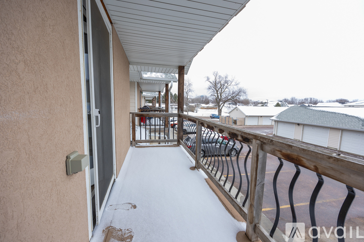 A balcony with a metal railing and a glass door.