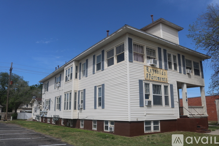 A building with a sign that says "Rent to Own Apartments".