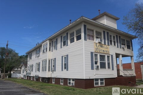A building with a sign that says "Rent to Own Apartments".