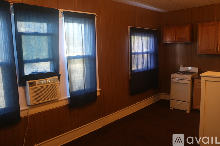 A room with brown walls and a white washing machine.