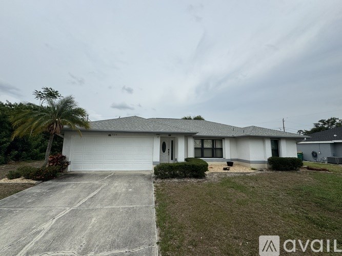 A house with a white garage door and a driveway in front.