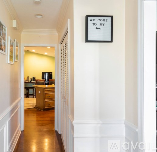 A hallway with a sign that says "Welcome to my home.".