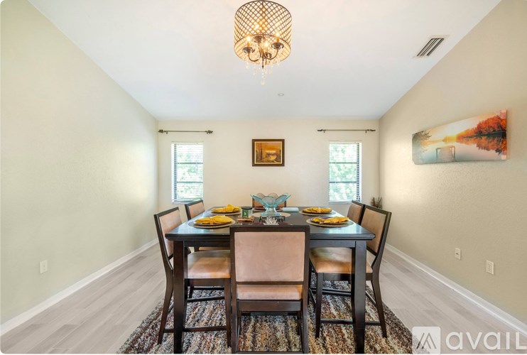 A dining room with a table set for four.