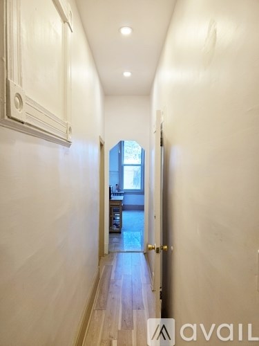 A long hallway with a door at the end.