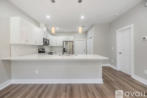A kitchen with white cabinets and a center island with a countertop.