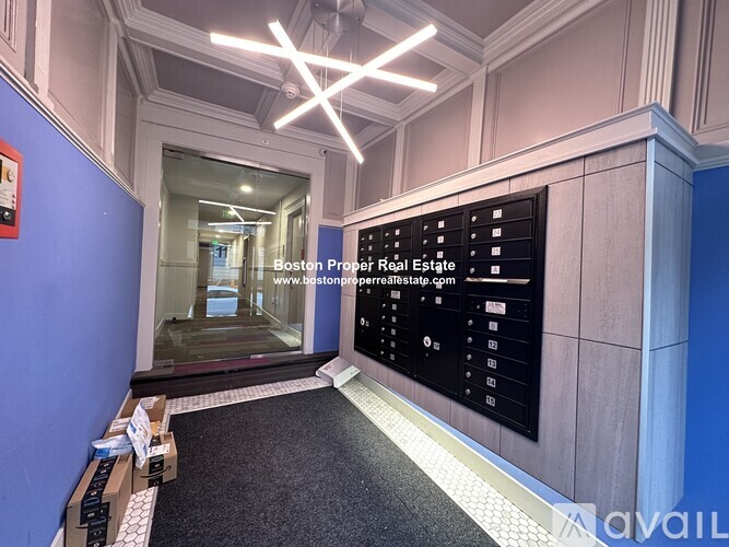 A reception area with a blue wall and a black reception desk.