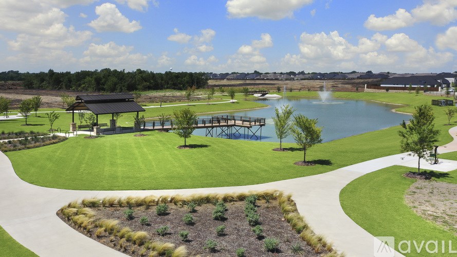 A park with a pond, a bridge, and a gazebo.