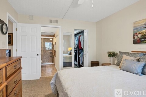 A bedroom with a large bed and a dresser.