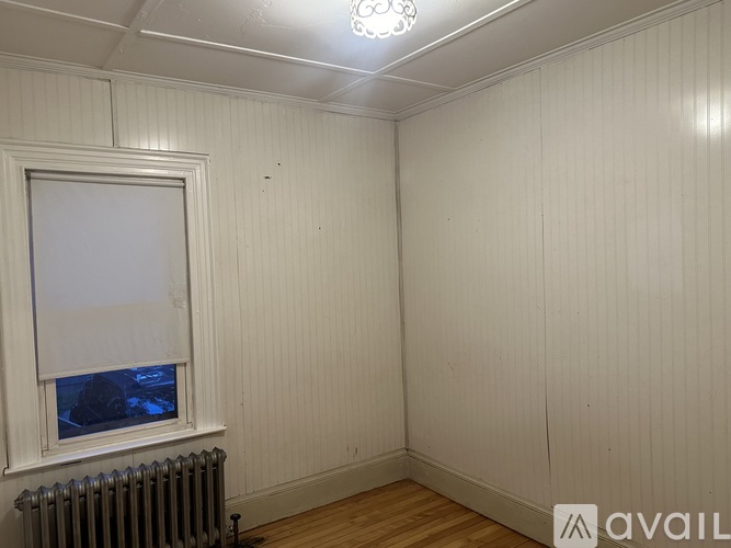 A room with a window and a radiator.