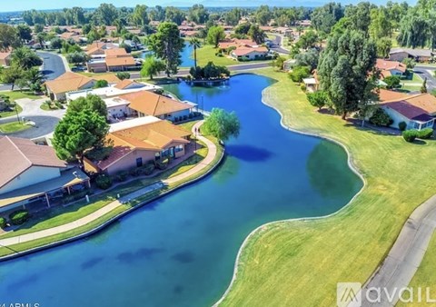A bird's eye view of a residential area with houses and a river.