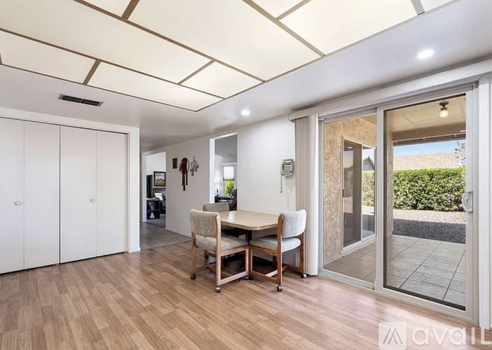 A dining area with a table and chairs is available for rent.