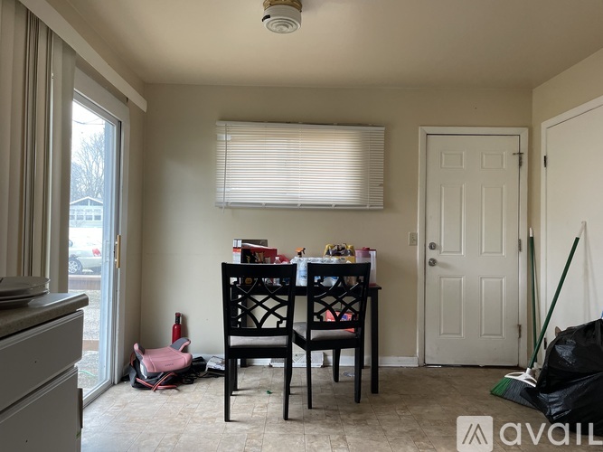 A dining room with a table and chairs.