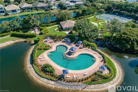 A bird's eye view of a luxurious property with a heart-shaped pool.