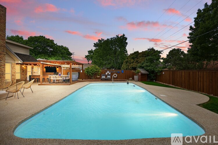 A backyard with a pool and a deck.