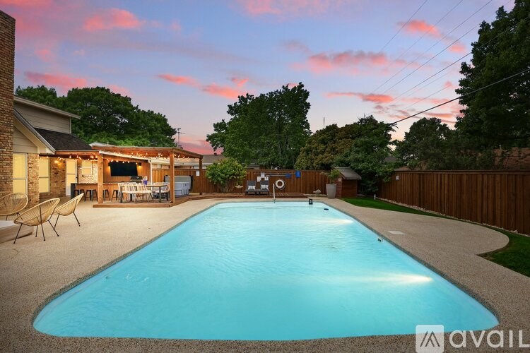A backyard with a pool and a deck.