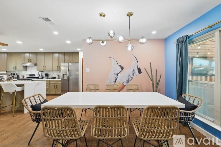 A modern kitchen with a dining table and chairs.
