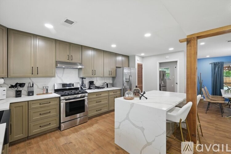 A modern kitchen with wooden cabinets and a white island.